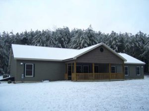 Exterior of home in the snow by Kucel Contractors