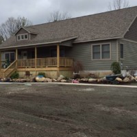 Exterior house by Kucel Contractors with a wooden porch